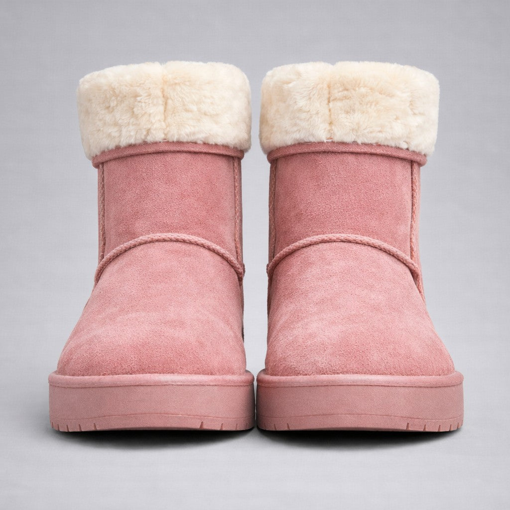 Pair of pink sheepskin winter boots with white merino wool fur lining.